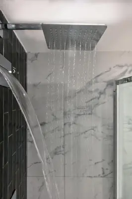 a shower in a bathroom with a waterfall at Fellini Design Suites in Rome