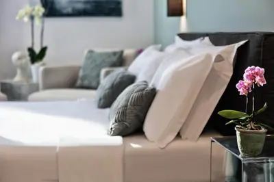 a white couch with pillows on it in a living room at Fellini Design Suites in Rome