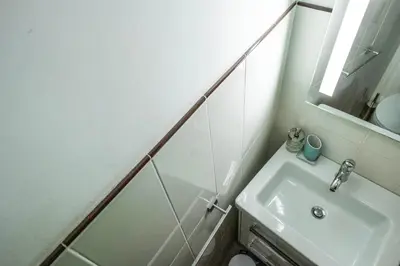 a white bathroom with a sink and a mirror at La Vite 94 in Rome