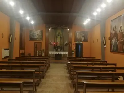 an aisle of a church with wooden pews at Casa per Ferie Suore Domenicane in Rome