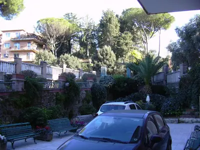 a car parked in a parking lot next to benches at Casa per Ferie Suore Domenicane in Rome