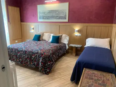 a hotel room with two beds and purple walls at B&B Acasadibarbara in Rome