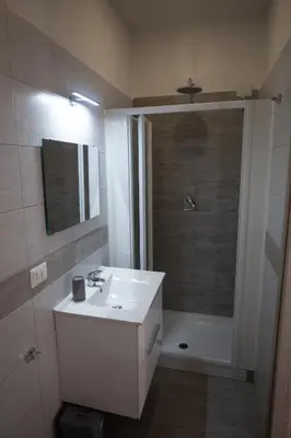 a bathroom with a white sink and a shower at Rooms Monteverde 2 in Rome