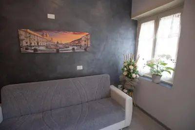 a living room with a couch and a painting on the wall at Rooms Monteverde 2 in Rome