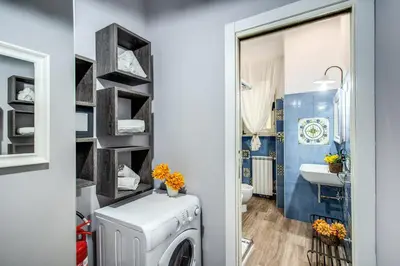 a laundry room with a washer and dryer and a bathroom at Ripetta Miracle Suite in Rome