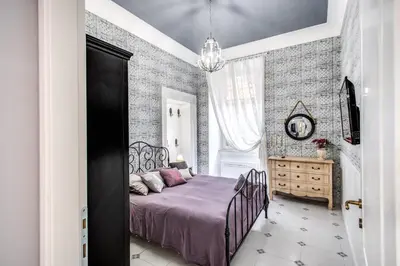 a bedroom with a bed with a purple bedspread at Ripetta Miracle Suite in Rome