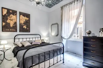 a bedroom with a bed and a dresser and a window at Ripetta Miracle Suite in Rome