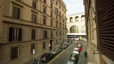a city street with cars parked on the side of buildings at Aquarium Termini in Rome