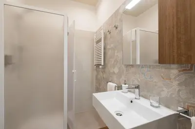 a white bathroom with a sink and a shower at B&B Abbraccia Morfeo in Rome