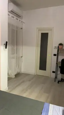 an empty room with a door and a table and a chair at Appartamento Remanton in Rome