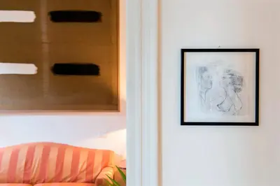 a door with a picture next to a couch at Flat Three in Rome