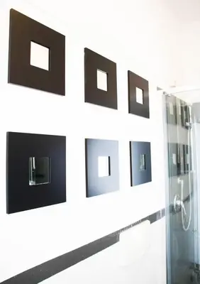 a bathroom with black and white pictures on the wall at Gallery Guesthouse in Rome