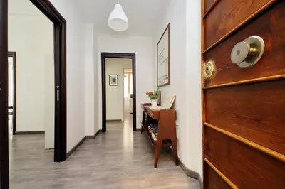 a hallway with a wooden door and a desk at Scipioni Terrace in Rome