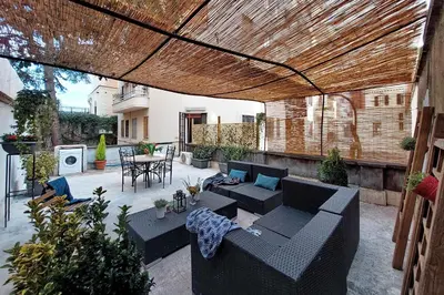 a patio with a table and chairs in a courtyard at Scipioni Terrace in Rome