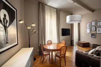 a living room with a table and chairs and a couch at Piazza di Spagna Moda Luxury Apartment in Rome
