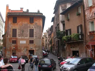 a city street with cars and people walking on the street at Core De Roma Suites in Rome