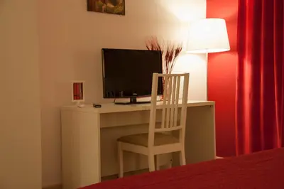 a desk with a computer monitor and a chair at Parco Delle Valli in Rome