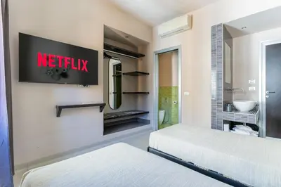 a netflix sign on a wall in a bedroom at Moai Home in Rome