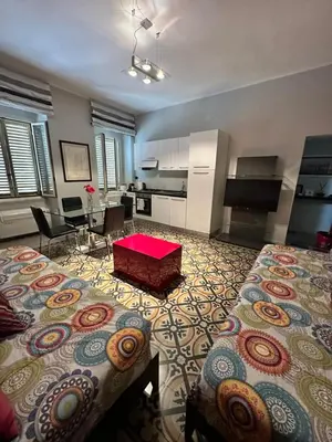 a large room with two beds and a table in it at Vatican Color House in Rome