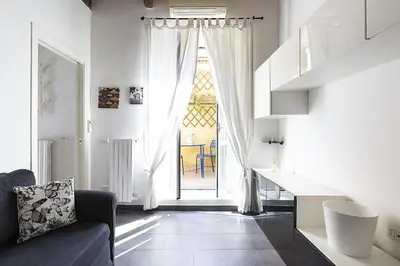a living room with a couch and a large window at Emma's Apartment Borgo, Vatican City in Rome