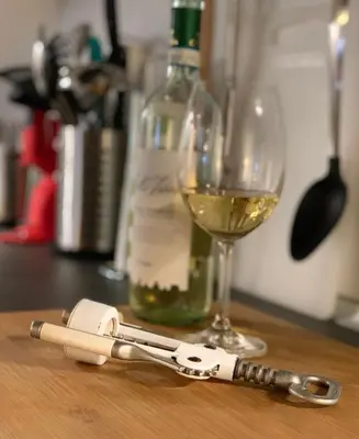 a bottle of wine and a glass of white wine at L’ARTSHOP in Rome