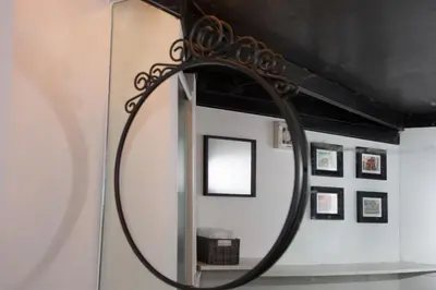 a mirror hanging on a wall with pictures at L’ARTSHOP in Rome