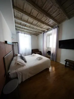 a bedroom with a large bed in a room at Nerva Accommodation in Rome