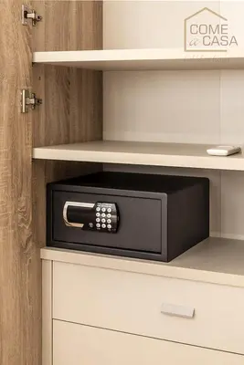 a black microwave oven sitting on a shelf at Come a Casa in Rome