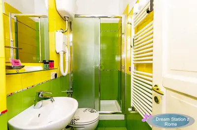a green bathroom with a sink and a shower at Dream Station 2 in Rome