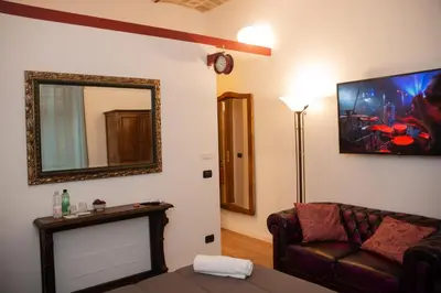 a living room with a couch and a mirror at Dillo Suites in Rome