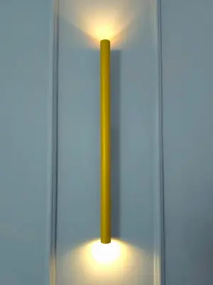 a yellow candle in a glass case with a light at B&B Aurelia Garden Rooms in Rome