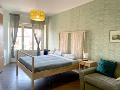 a bedroom with a bed and a couch at Bibbi's House San Lorenzo in Rome