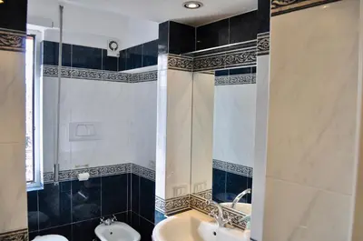 a bathroom with a sink and a toilet and a shower at Alloggio Turistico Roberta San Pietro in Rome