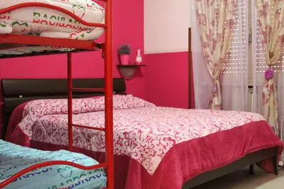 a bedroom with two bunk beds and pink walls at Aracoeli in Rome