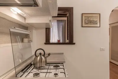 a tea kettle sitting on top of a stove in a kitchen at GuestHost - Fori Imperiali Apartment in Rome