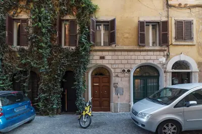 a motorcycle parked in front of a building at GuestHost - Fori Imperiali Apartment in Rome