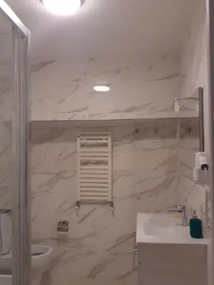 a white bathroom with a sink and a toilet at ABID'S PALACE IN TERMINI in Rome