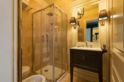a bathroom with a shower and a sink and a toilet at Profumo Maison Colosseo in Rome