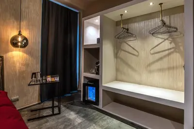 a living room with a wall with shelves at Black And White Suite in Rome
