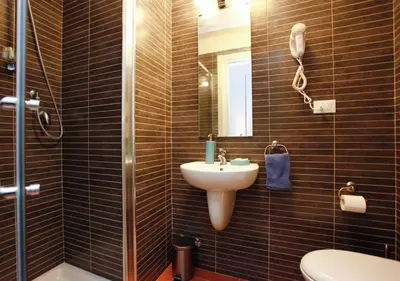 a bathroom with a sink and a toilet and a mirror at Clemy In Rome in Rome