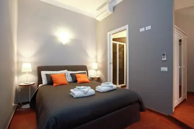 a bedroom with a bed with two towels on it at Clemy In Rome in Rome