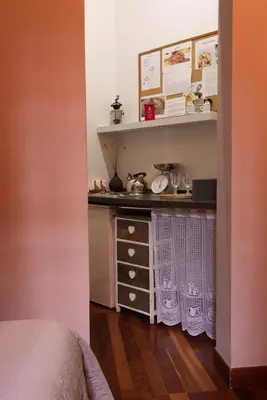 a room with a shelf and a dresser in a room at Suite Michelangelo in Rome