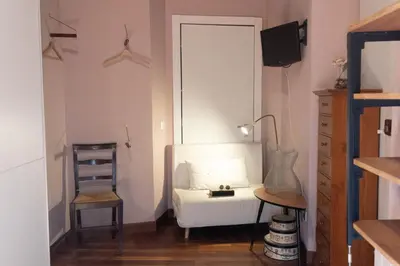 a living room with a white couch and a chair at Suite Michelangelo in Rome