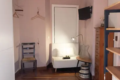 a living room with a white couch and a chair at Suite Michelangelo in Rome