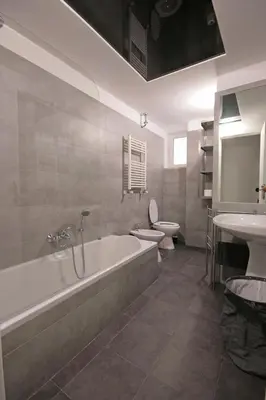 a bathroom with a tub and a toilet and a sink at Trastevere 3 bedrooms in Rome