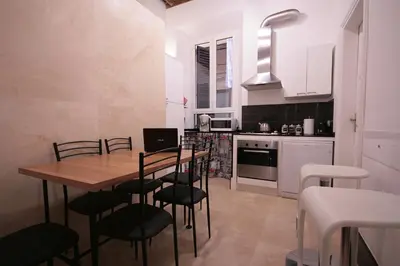 a kitchen with a wooden table and chairs in it at Trastevere 3 bedrooms in Rome