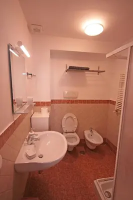 a bathroom with a sink and a toilet at Trastevere 3 bedrooms in Rome