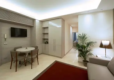 a living room with a table and chairs and a tv at Harry's Bar Trevi Luxury Apartments - Mignanelli in Rome