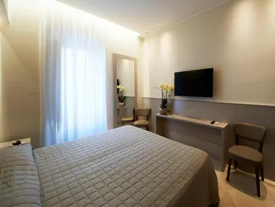 a bedroom with a bed and a flat screen tv at Harry's Bar Trevi Luxury Apartments - Mignanelli in Rome