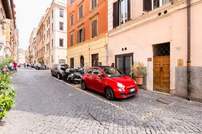 a red car parked on the side of a street at LIVING COLOSSEUM in Rome